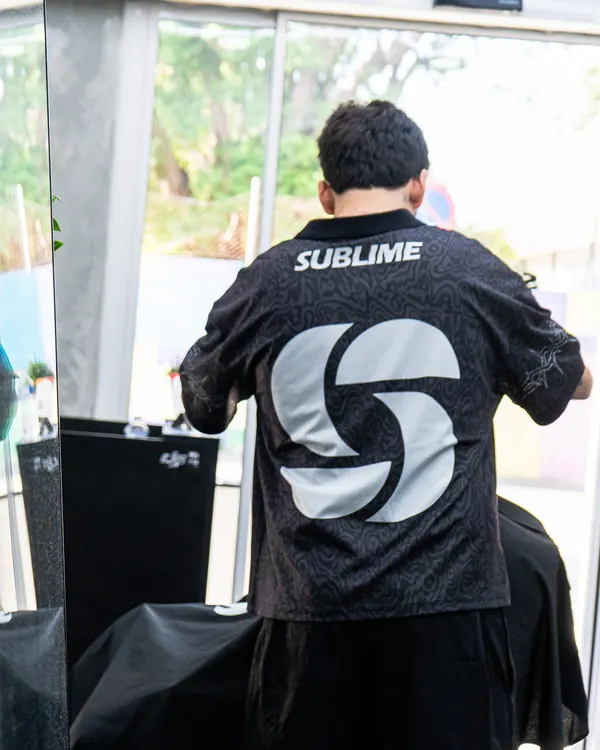 Barbero de Sublime de espaldas, junto a la puerta del estudio llena de luz